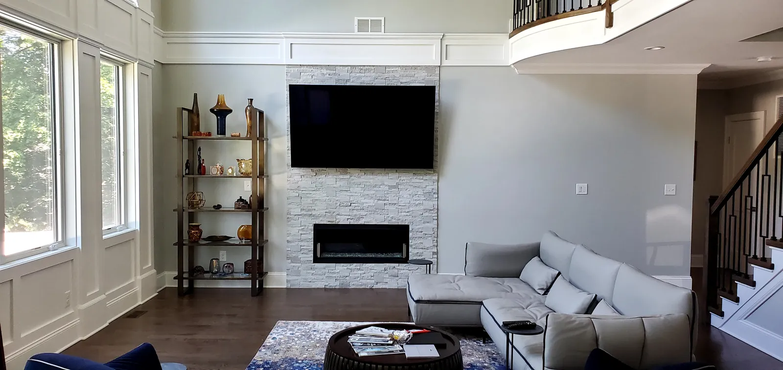 Wall-mounted TV on a stone fireplace with hidden wiring